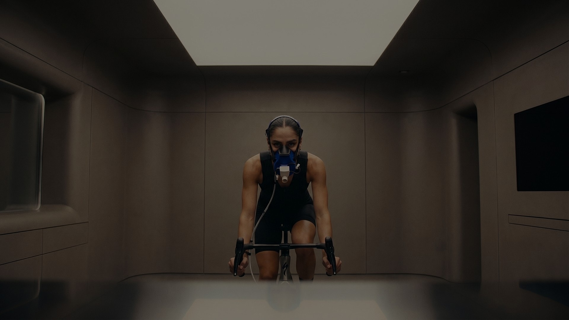 metabolic testing patient model cycling with performance masks in laboratory.