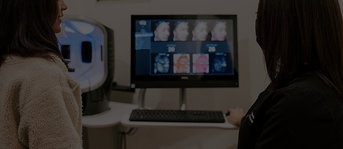 Analyzing skin data on computer monitor display.