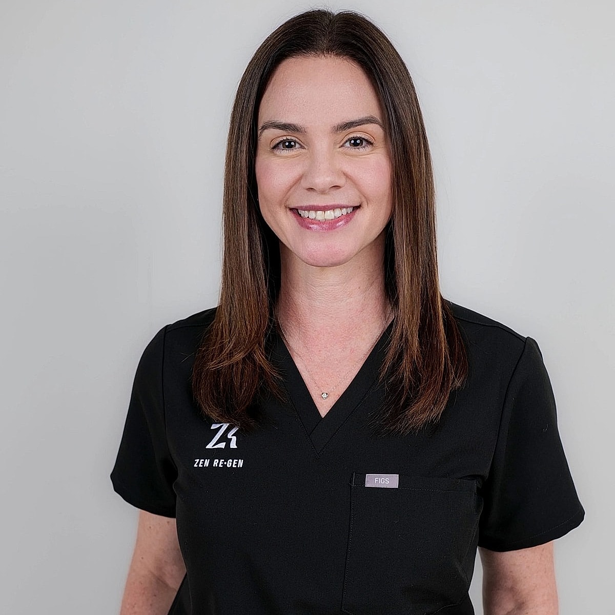 Healthcare professional smiling in black scrubs.