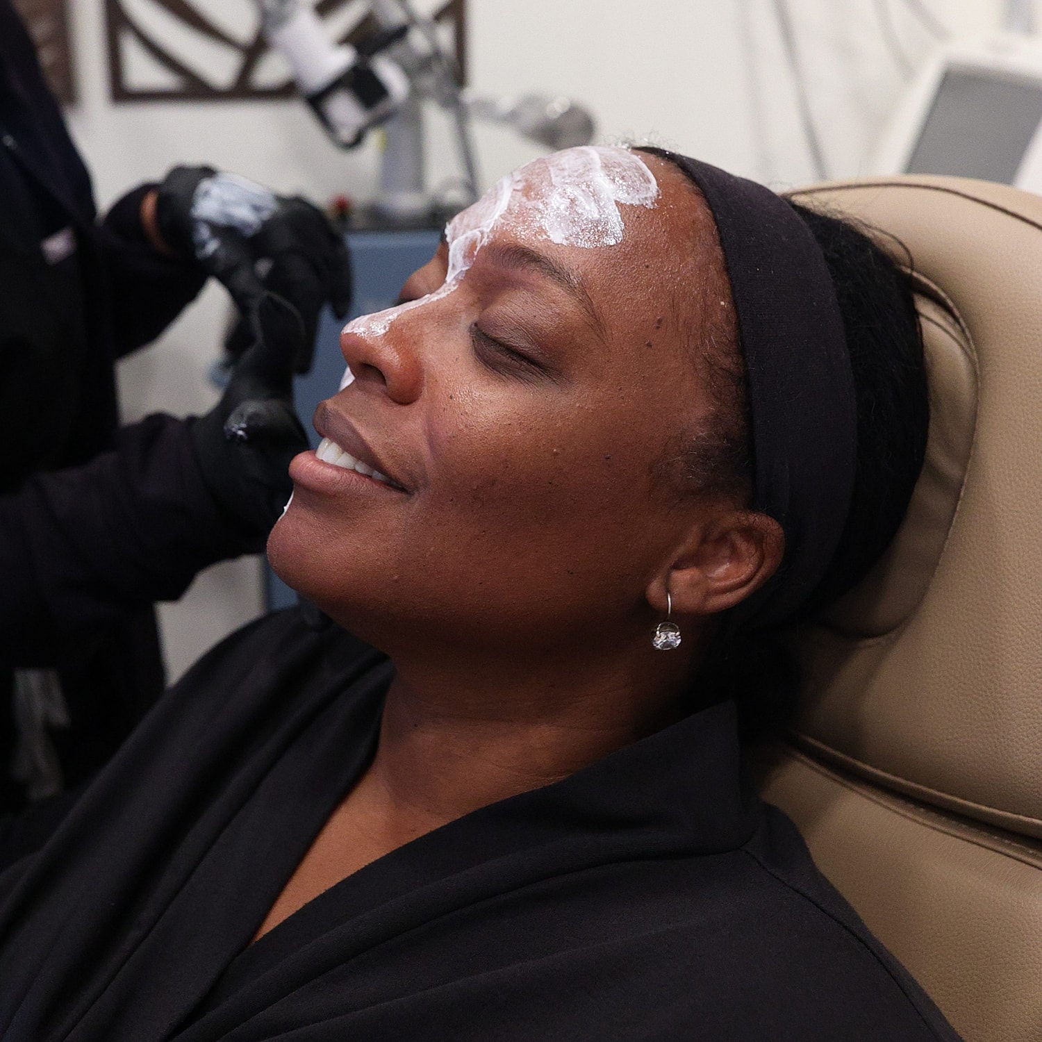 Woman enjoying a facial treatment at spa.