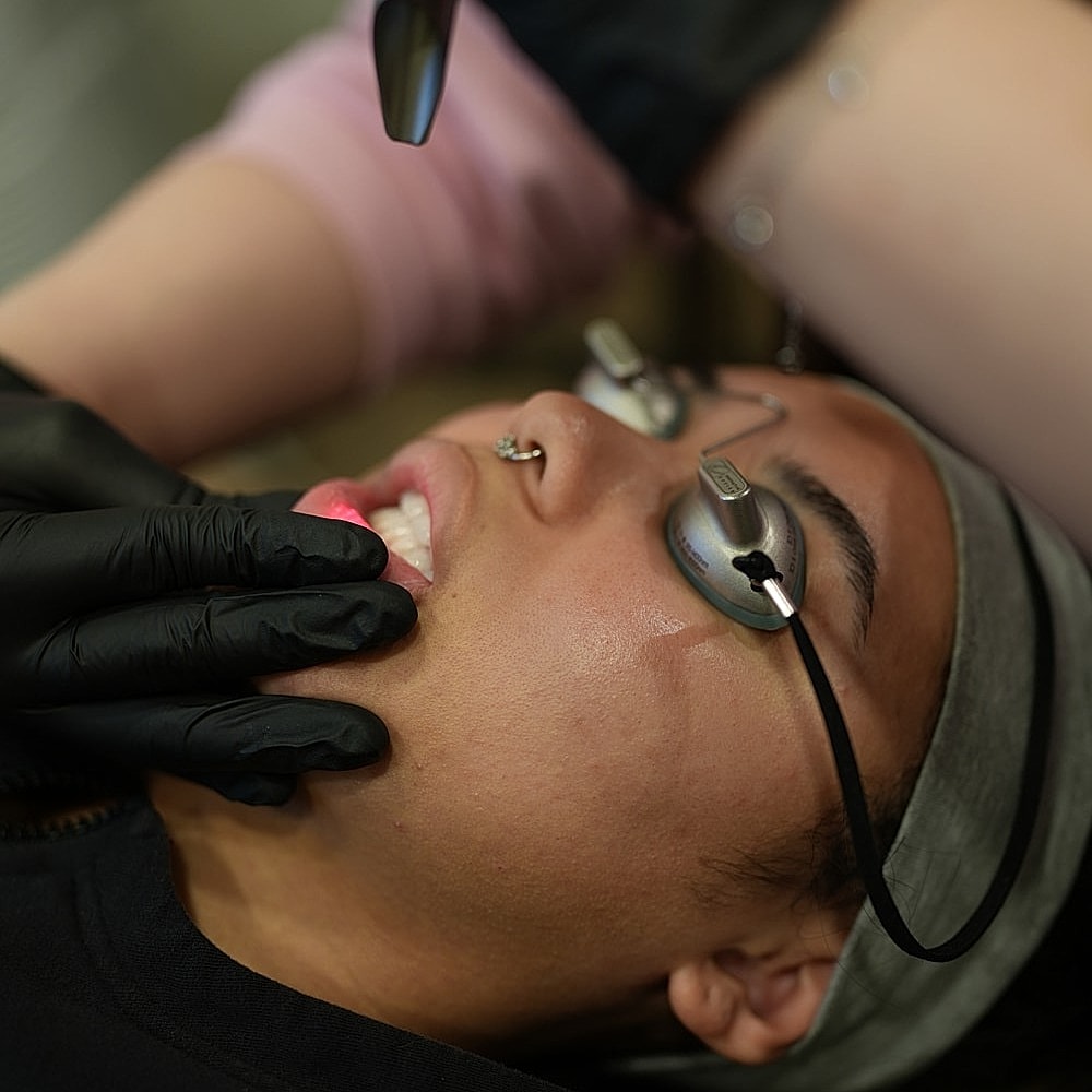 Facial treatment procedure in progress with client.