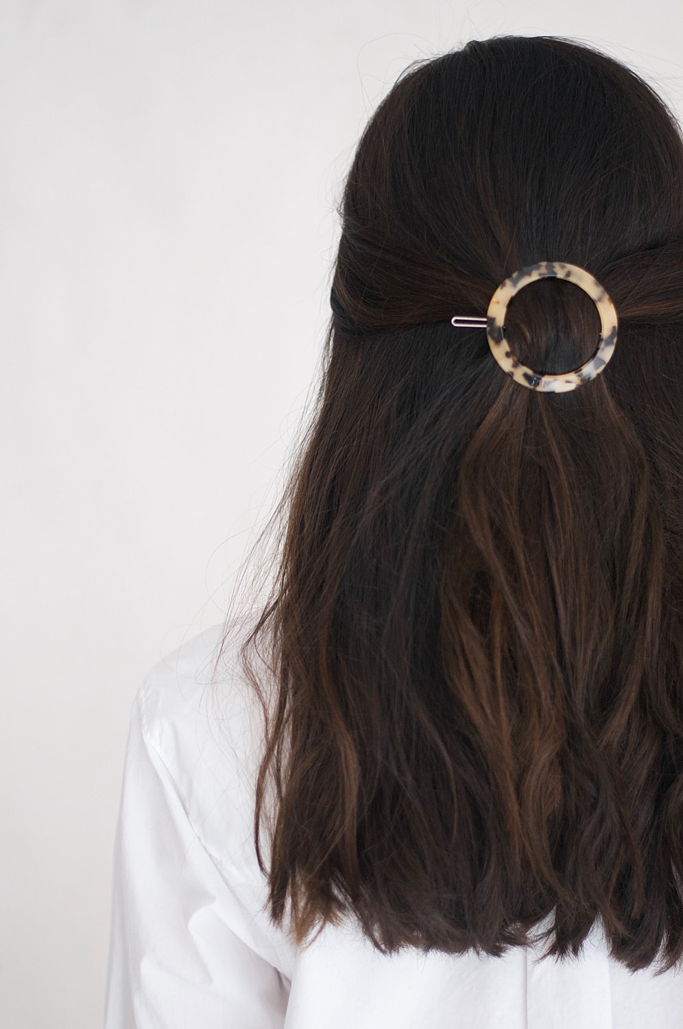 Woman's hair styled with a circular clip.