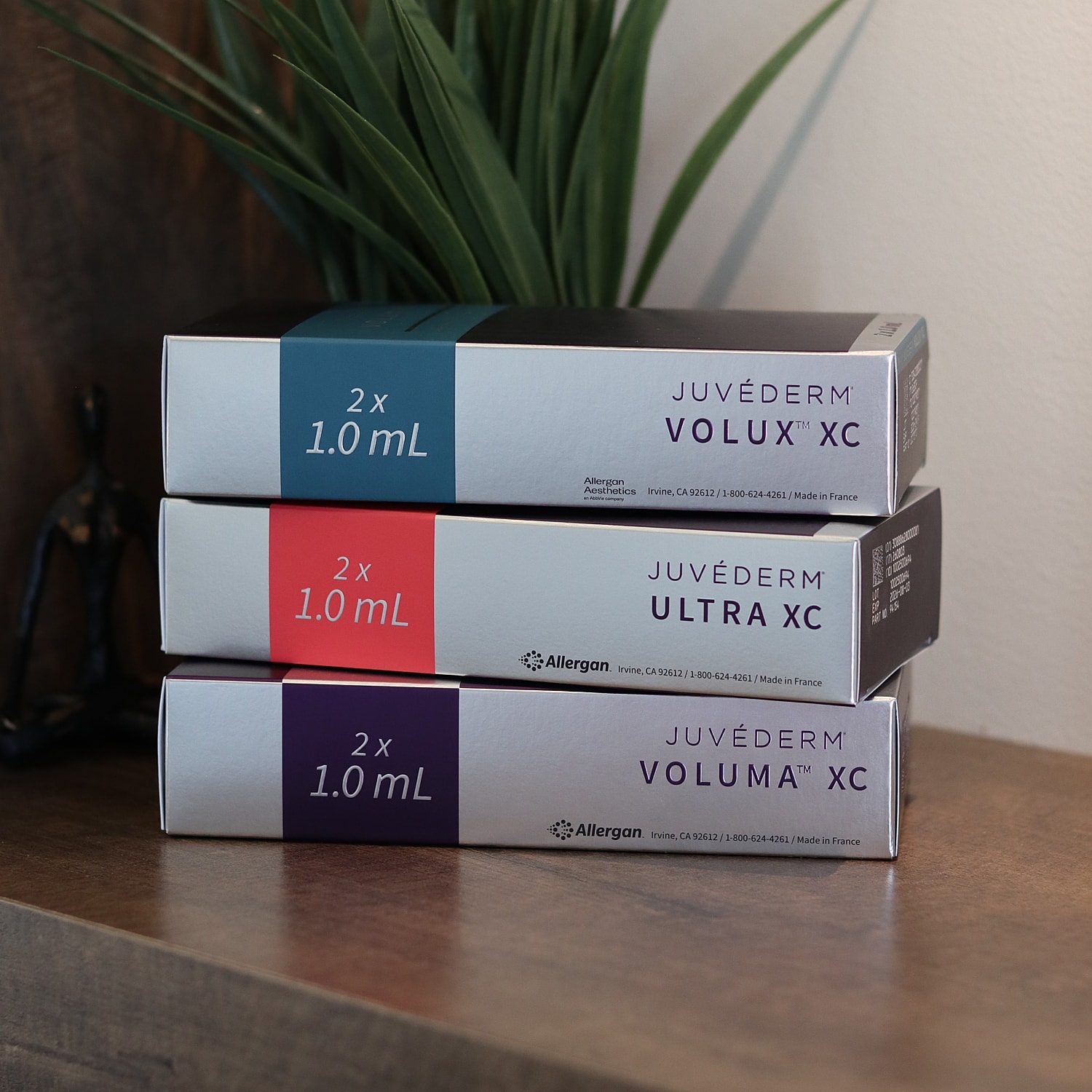 Juvéderm product boxes on wooden surface.
