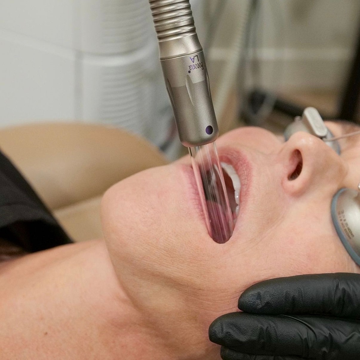 Medical procedure using dental equipment on patient.