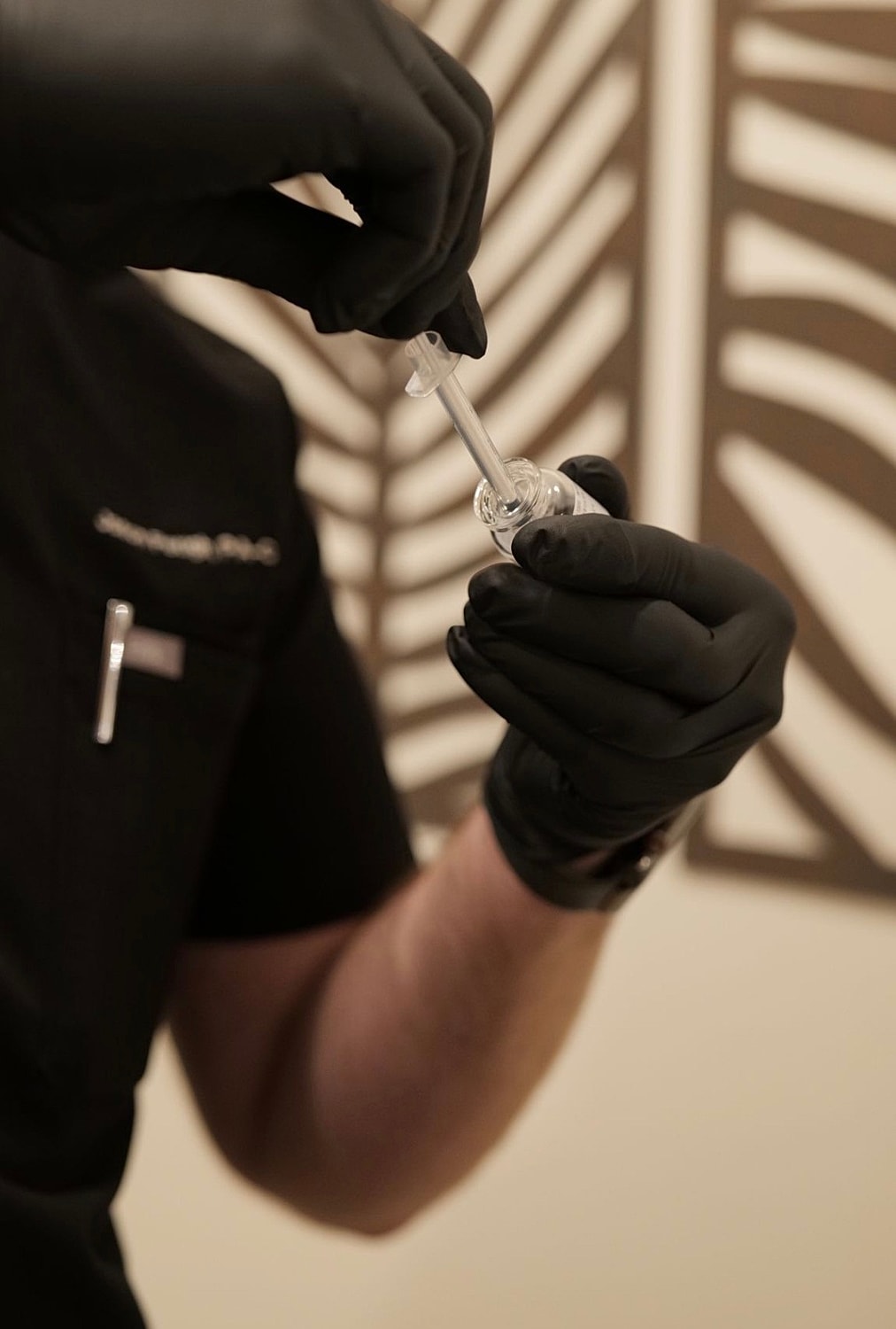 Preparing a vial with a dropper tool.