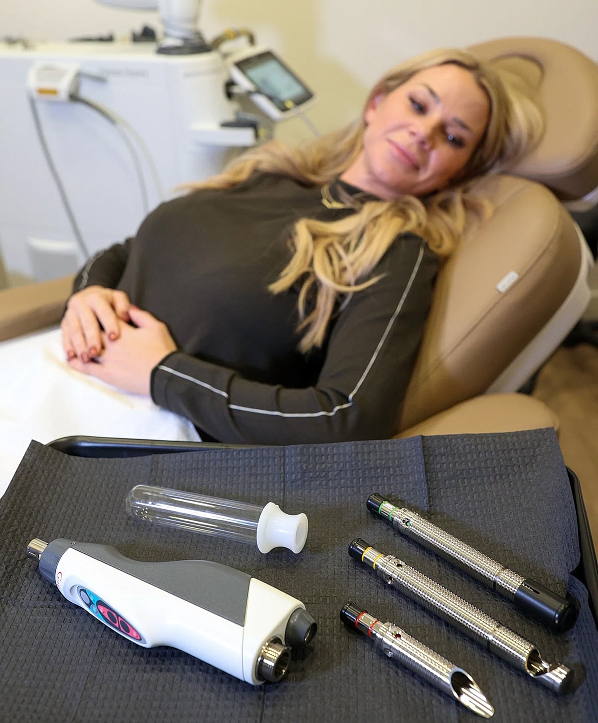 Woman undergoing beauty treatment with tools nearby.