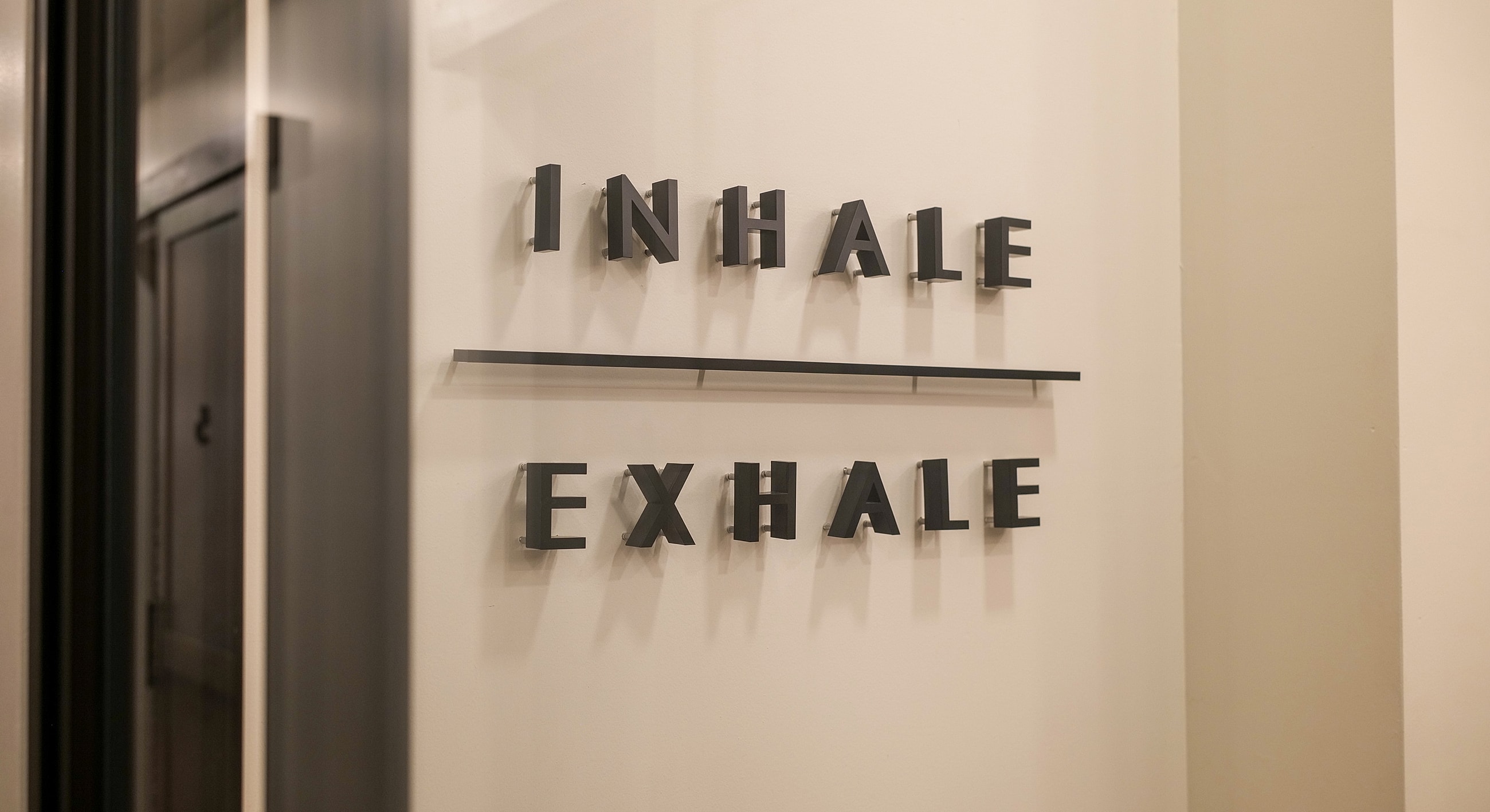 Inhale and exhale wall sign in minimal design.