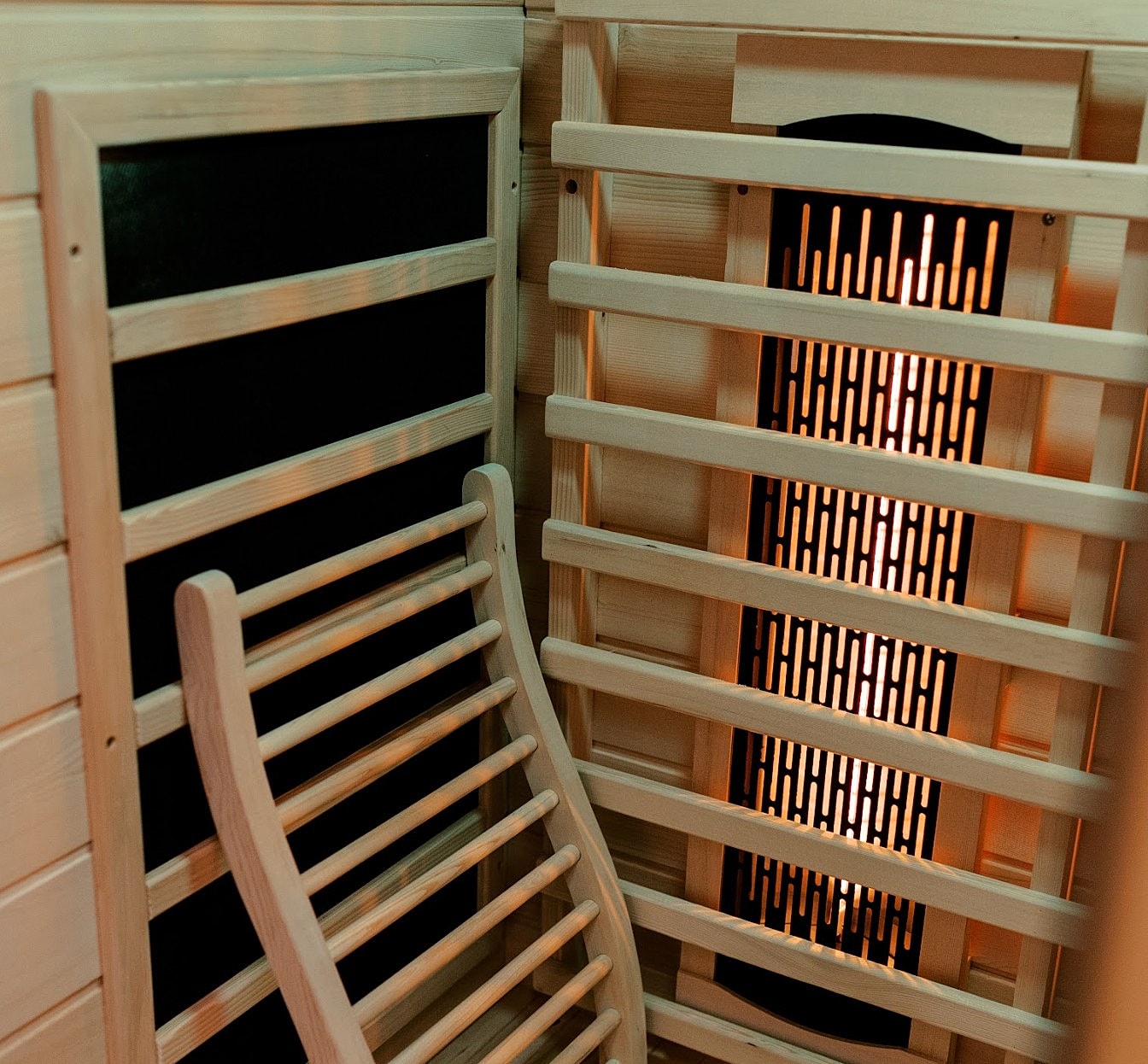 Interior of a wooden sauna with glowing heater.
