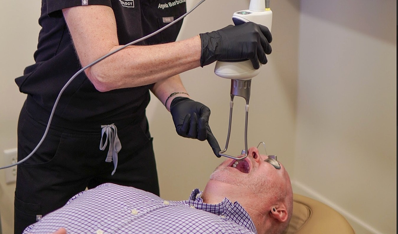 Dental treatment using laser technology on patient.