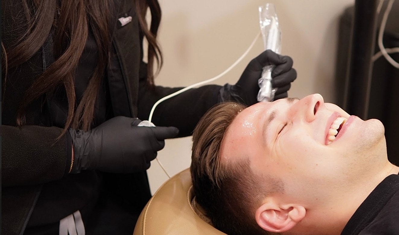 Man receiving a facial treatment in salon.